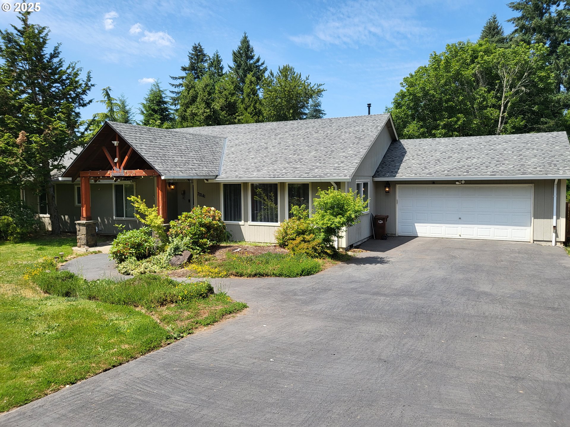 a front view of a house with a garden