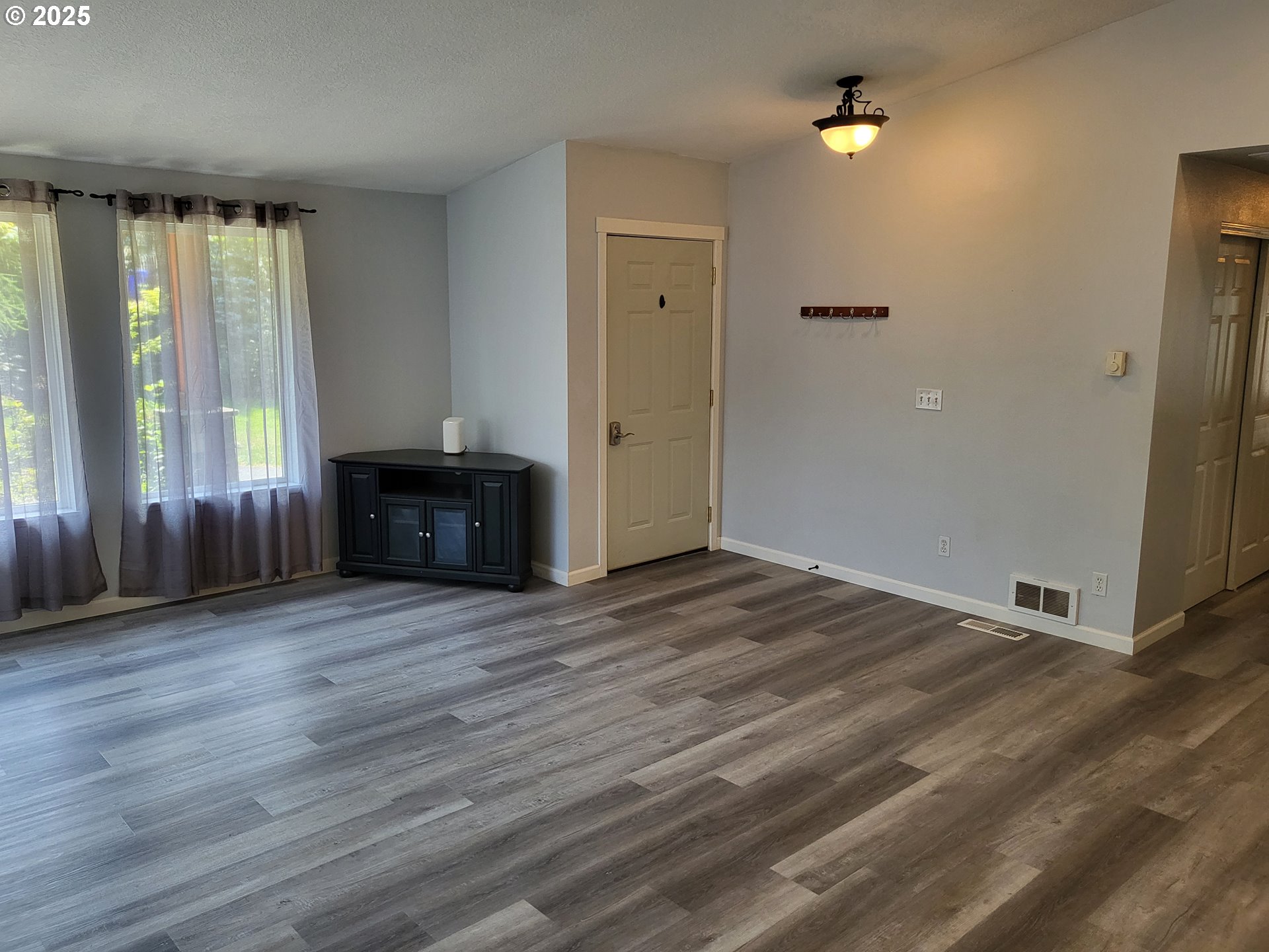 32141 Southeast Mally Road Gresham, OR 97080 - Photo 3 of 36 an empty room with wooden floor and windows