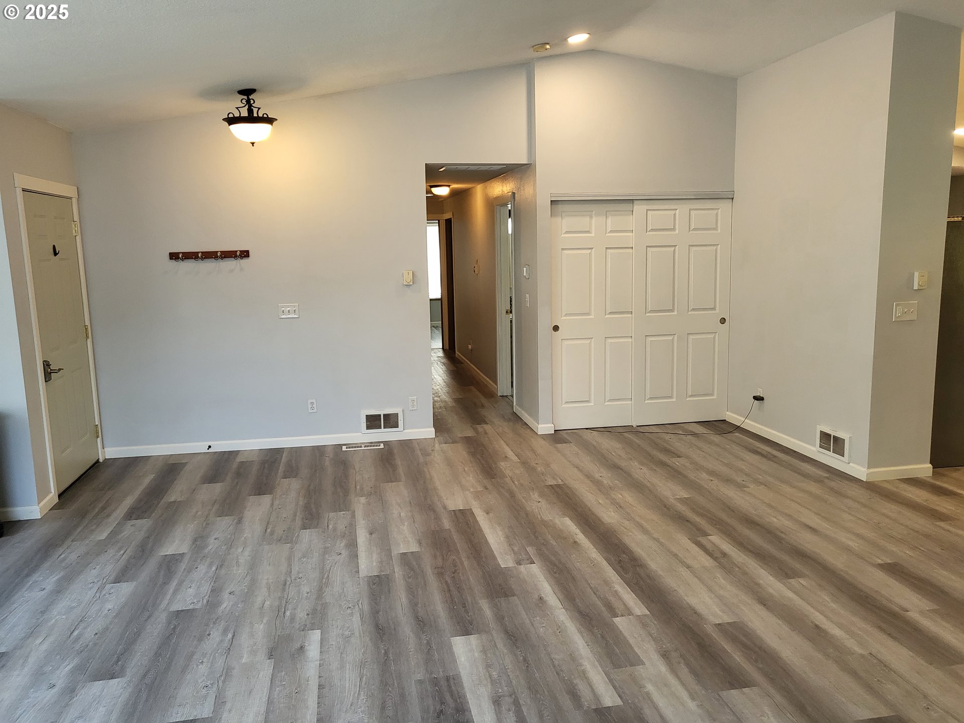 32141 Southeast Mally Road Gresham, OR 97080 - Photo 4 of 36 an empty room with wooden floor and white doors