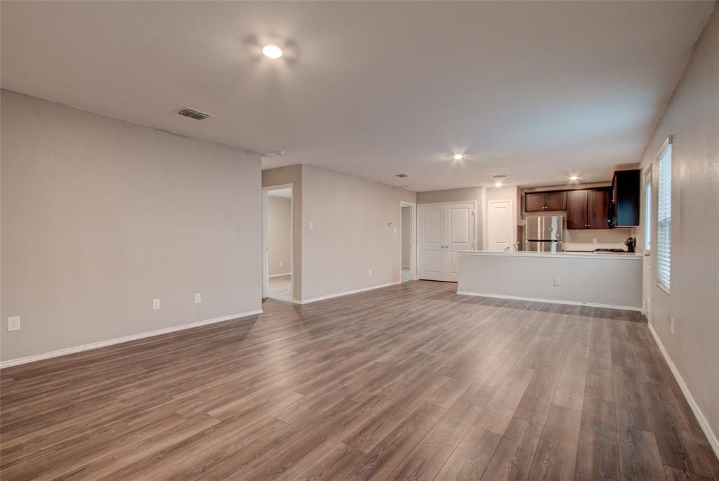 5817 Grindstone Drive Forney, TX 75126 - Photo 3 of 18 a view of a kitchen with wooden floor and a window