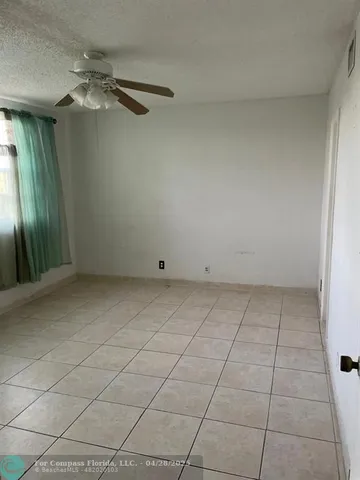 an empty room with a empty space and a bathroom