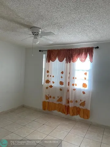 an empty room with a fireplace and a shower curtain