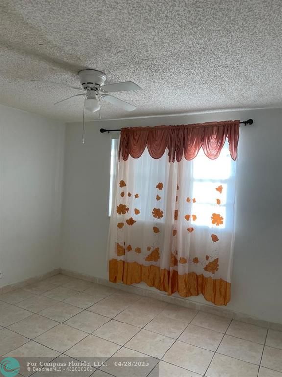 3900 Northwest 76th Avenue Sunrise, FL 33351 - Photo 5 of 7 an empty room with a fireplace and a shower curtain