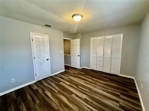 a view of a room with wooden floor