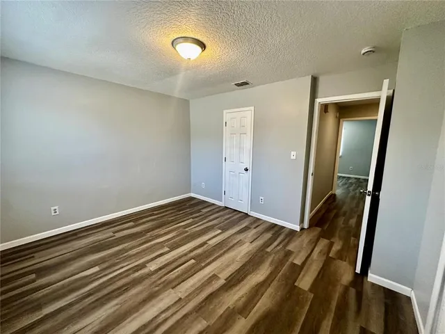 a view of a room with wooden floor