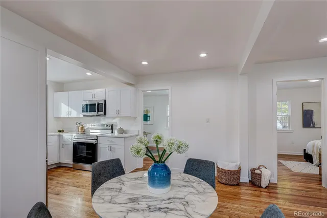 a living room with furniture a fireplace and a potted plant