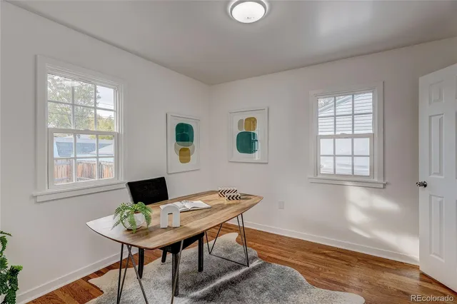 a view of a dining room with a table and chairs