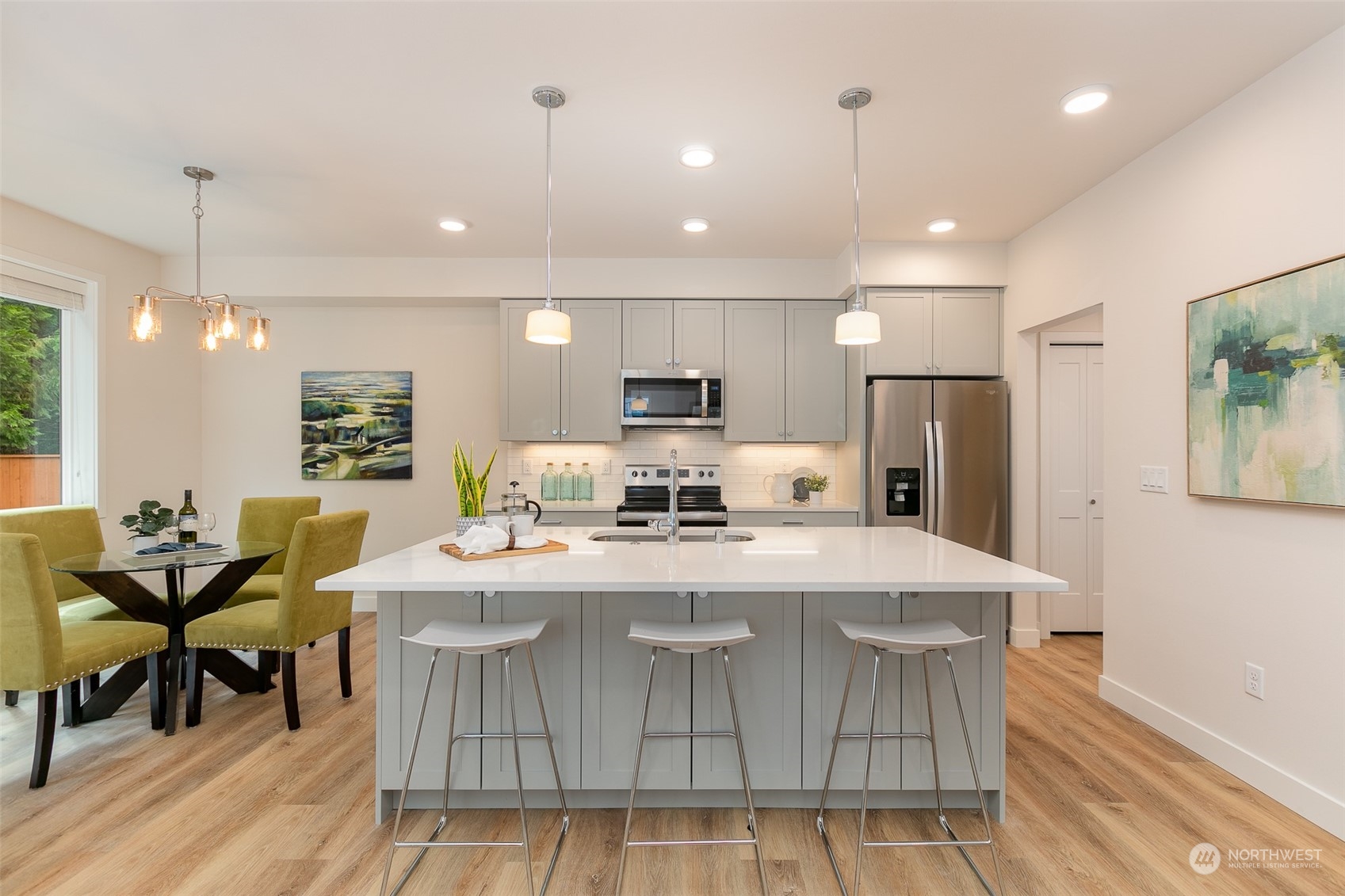 122 171st Place Southwest, Unit A Bothell, WA 98012 - Photo 7 of 26 a large kitchen with sink a refrigerator and chairs