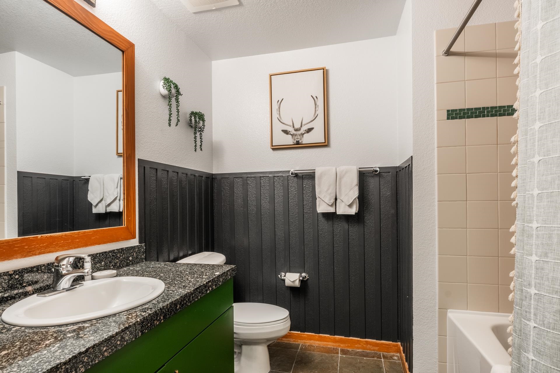 6201 Minaret Road, Unit 2221 Mammoth Lakes, CA 93546 - Photo 13 of 32 Bathroom featuring a vanity with a dark speckled countertop, an integrated sink, and a bright green cabinet base