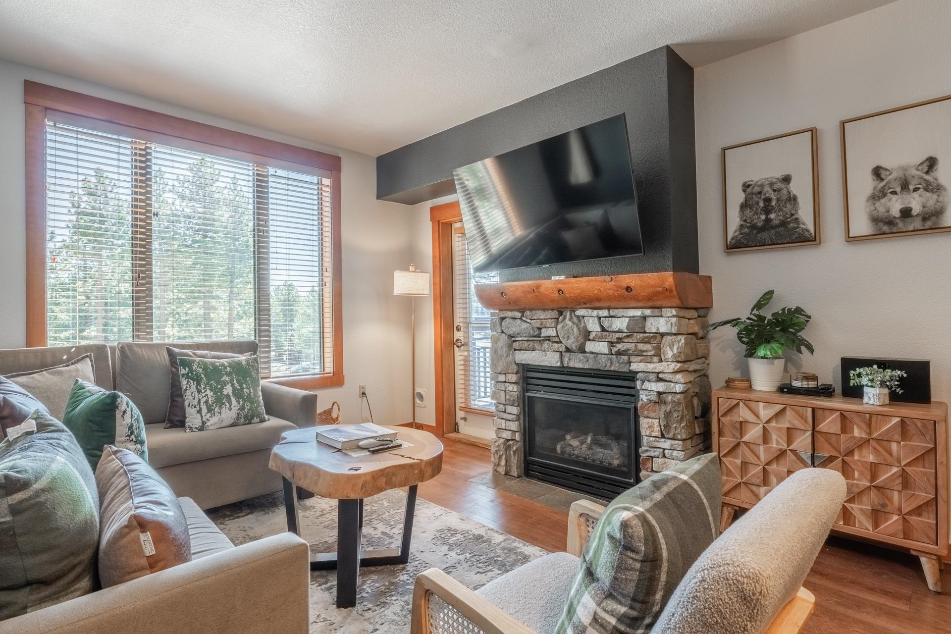 6201 Minaret Road, Unit 2221 Mammoth Lakes, CA 93546 - Photo 19 of 32 Living area featuring a stone-clad fireplace with a substantial log mantel