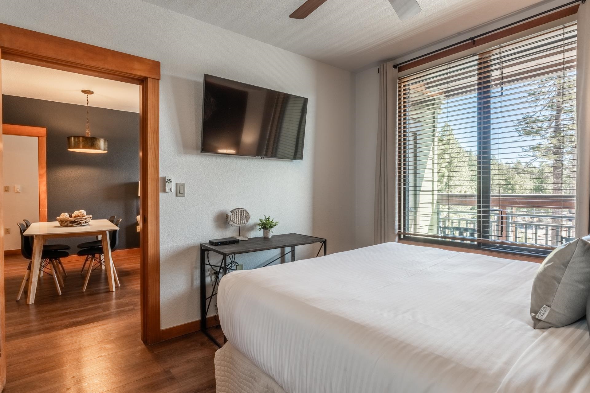 6201 Minaret Road, Unit 2221 Mammoth Lakes, CA 93546 - Photo 22 of 32 Bedroom featuring a wall-mounted television and a full-light glass door opening to a private balcony