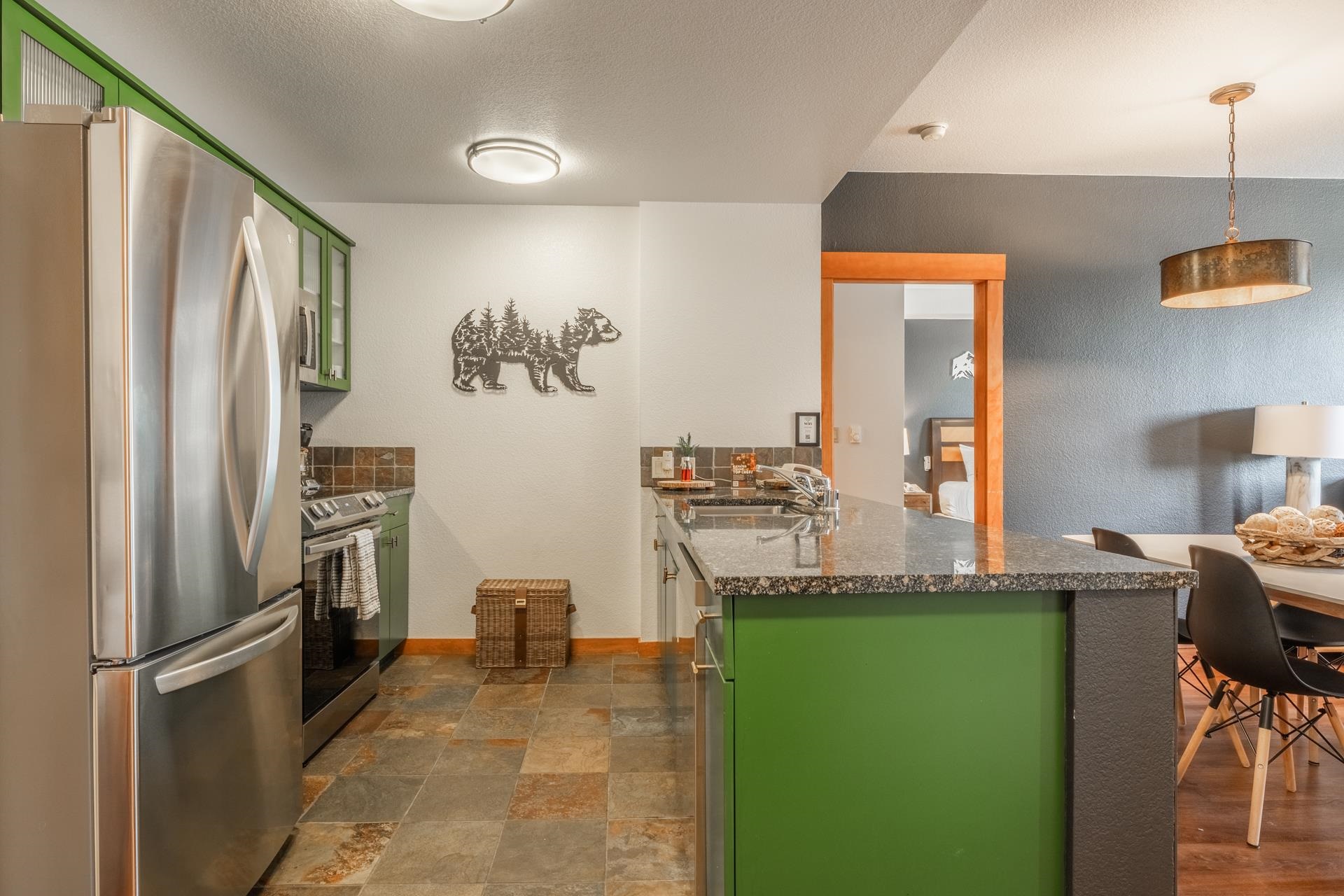 6201 Minaret Road, Unit 2221 Mammoth Lakes, CA 93546 - Photo 6 of 32 Kitchen featuring stainless steel appliances, green cabinetry, and tile flooring