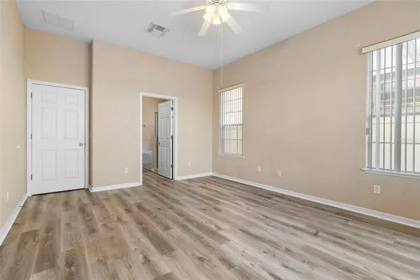 a view of an empty room with wooden floor