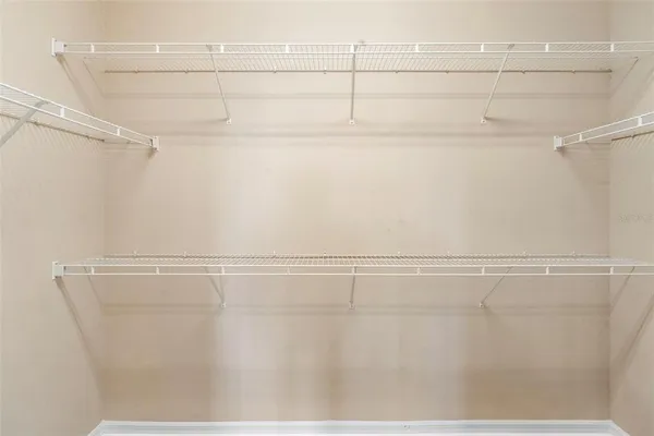 a view of an empty room with window and cabinet