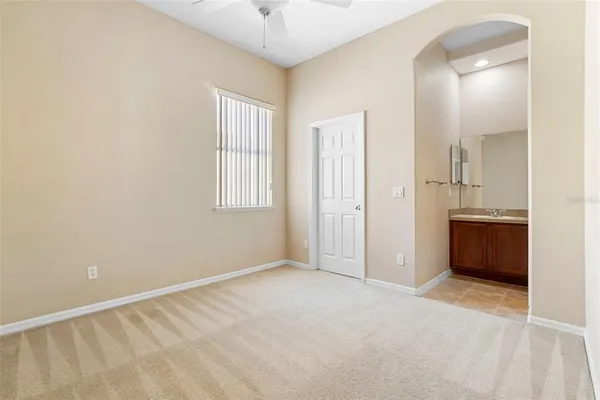 an empty room with closet and a bathroom