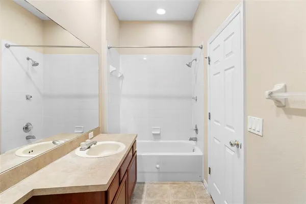 a bathroom with a sink a mirror and a bathtub