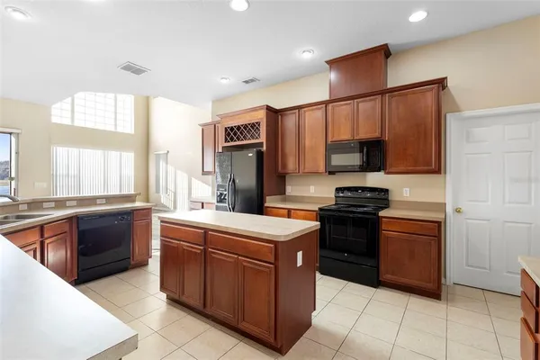 a kitchen with a stove a sink and a refrigerator