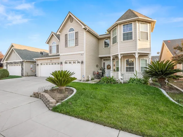 a front view of a house with a yard and garage