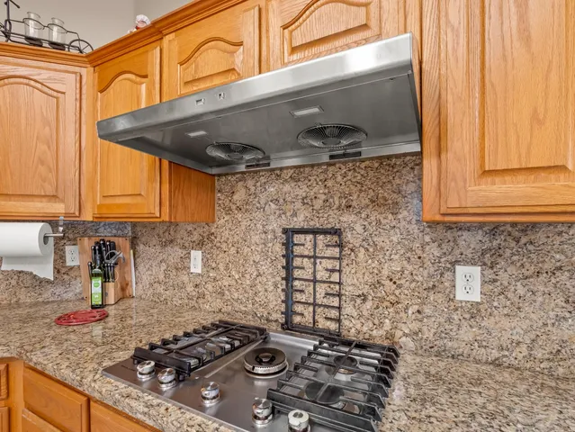 a kitchen with a stove and a cabinets