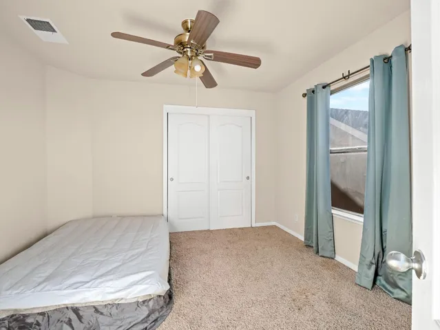 a view of a room with a ceiling fan
