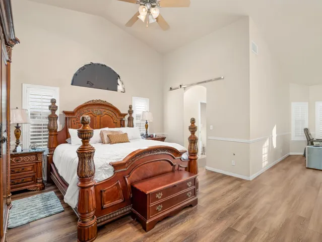 a bedroom with bed and a chandelier