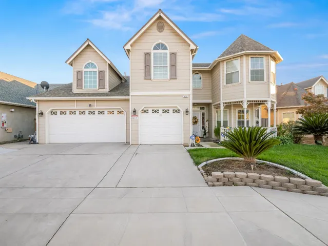 a front view of a house with a yard and garage