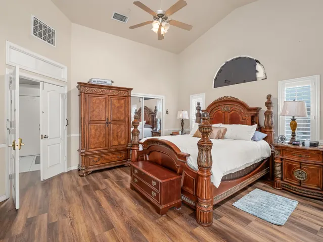 a bedroom with a bed and wooden floor