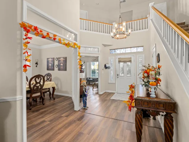 a view of a dining room with furniture and chandelier