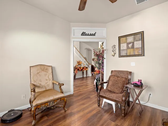 a living room with furniture and wooden floor
