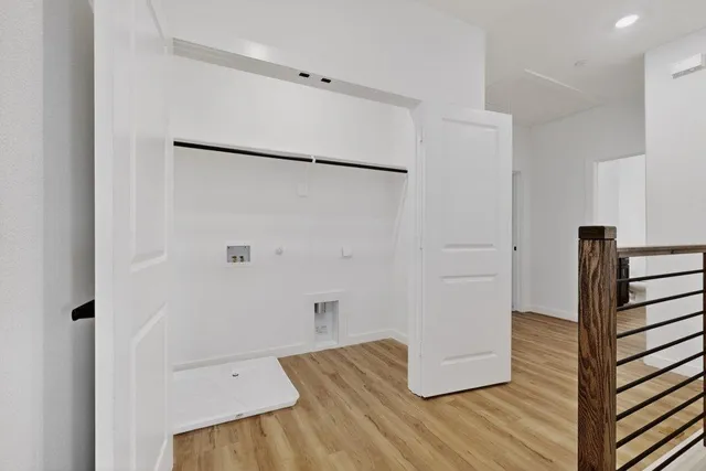 a view of hallway with wooden floor