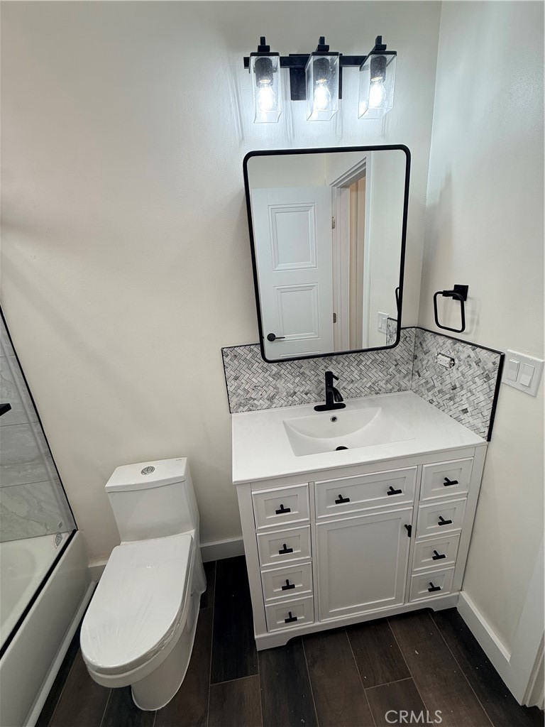 1522 Centinela Avenue, Unit 101 Los Angeles, CA 90025 - Photo 11 of 22 a bathroom with a toilet sink and mirror