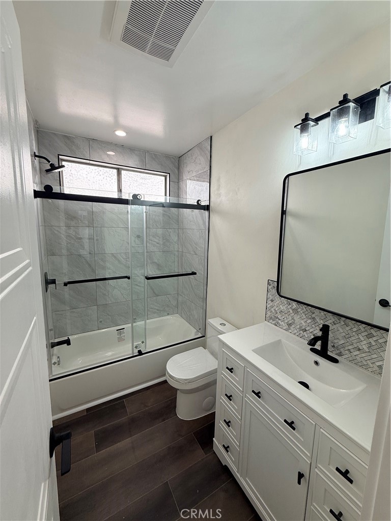 1522 Centinela Avenue, Unit 101 Los Angeles, CA 90025 - Photo 12 of 22 a bathroom with a double vanity sink toilet and shower