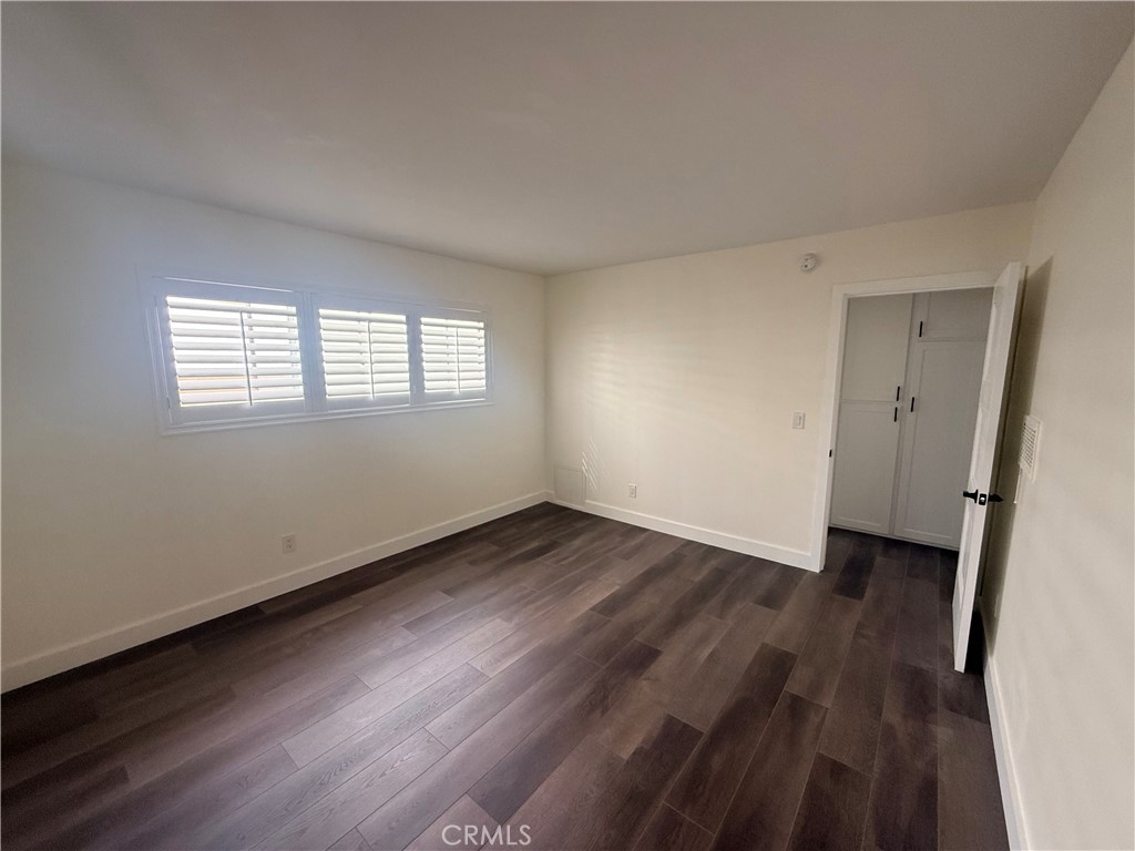 1522 Centinela Avenue, Unit 101 Los Angeles, CA 90025 - Photo 14 of 22 an empty room with wooden floor and windows