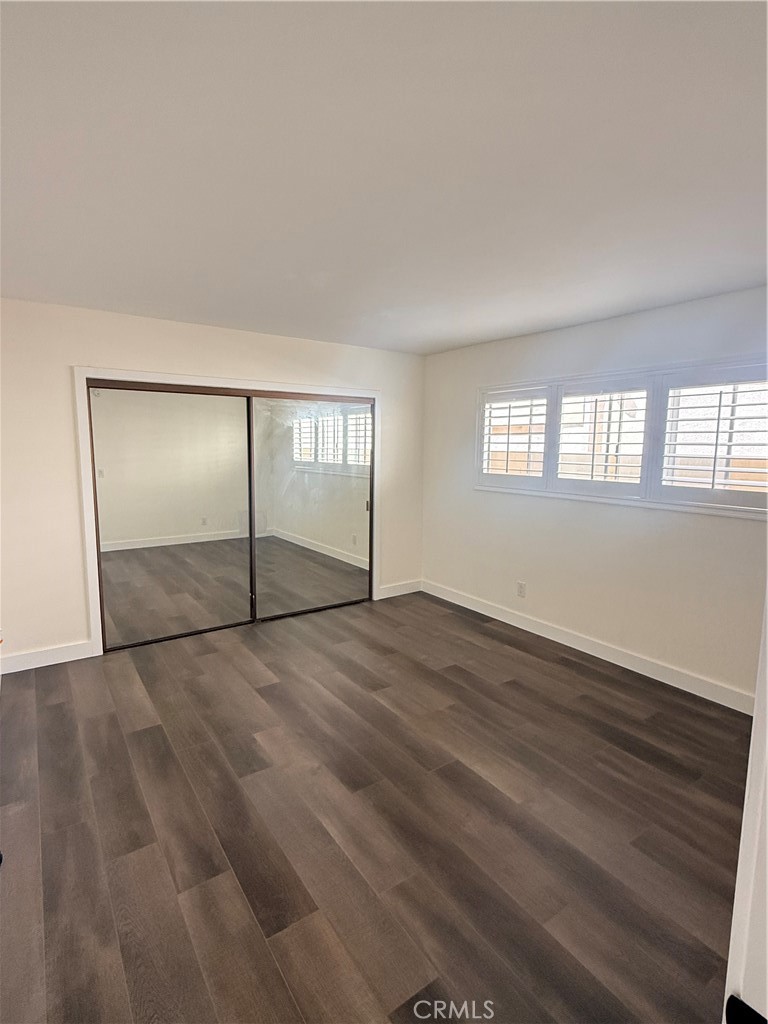 1522 Centinela Avenue, Unit 101 Los Angeles, CA 90025 - Photo 15 of 22 an empty room with wooden floor and windows