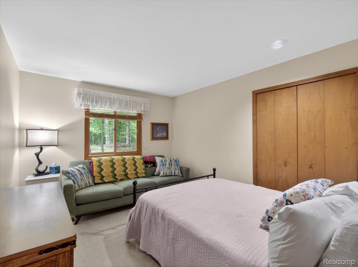 9714 Naiad Road Clarkston, MI 48348 - Photo 29 of 61 Carpeted room with a double-door wood-finish closet and recessed lighting