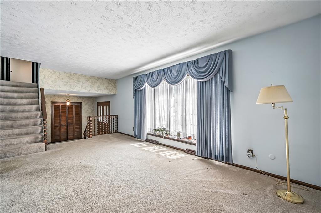 1471 George Street Hermitage, PA 16148 - Photo 18 of 49 an empty room with a fireplace and a large window