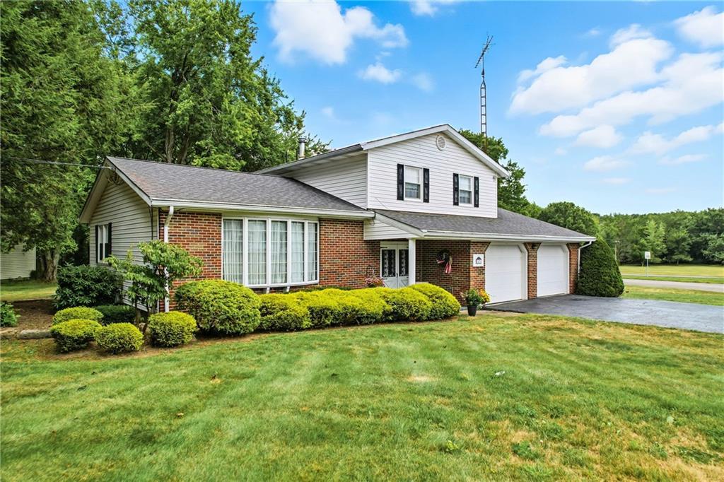 1471 George Street Hermitage, PA 16148 - Photo 2 of 49 a front view of a house with a yard and garage