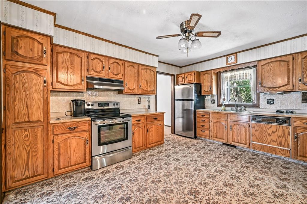 1471 George Street Hermitage, PA 16148 - Photo 25 of 49 a kitchen with stainless steel appliances granite countertop a stove sink and cabinets
