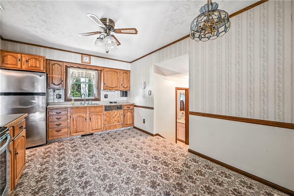 1471 George Street Hermitage, PA 16148 - Photo 26 of 49 a kitchen with stainless steel appliances granite countertop a refrigerator a sink dishwasher a stove with white cabinets and wooden floor