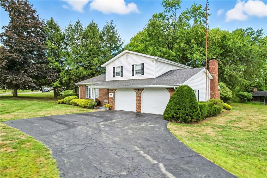 1471 George Street Hermitage, PA 16148 - Photo 3 of 49 a front view of a house with a yard and garage