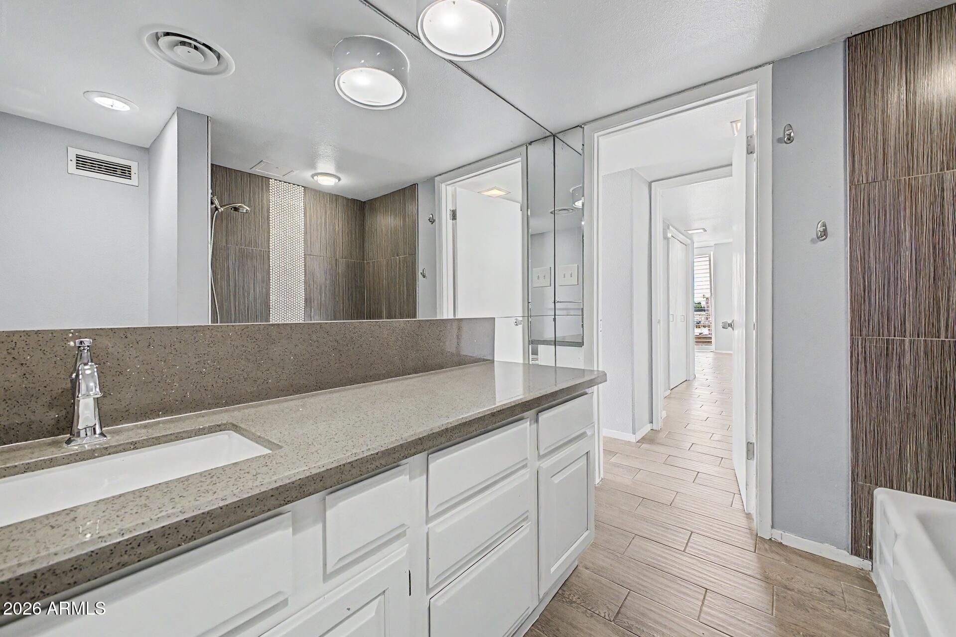 207 West Clarendon Avenue, Unit B2 Phoenix, AZ 85013 - Photo 12 of 30 a bathroom with a double vanity sink and a mirror