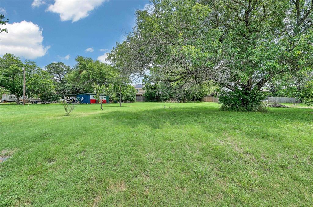 538 River Park Road McGregor, TX 76657 - Photo 2 of 6 a view of a park with large trees and a wooden fence
