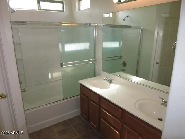 a bathroom with a sink and mirror