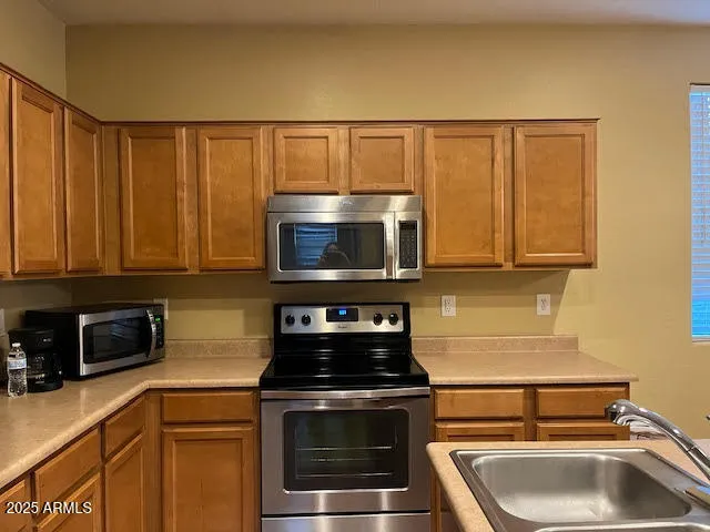 a kitchen with a sink and a stove top oven