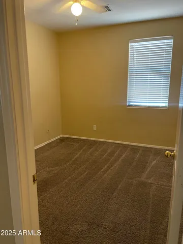 a view of a room with rack on the wall and a window