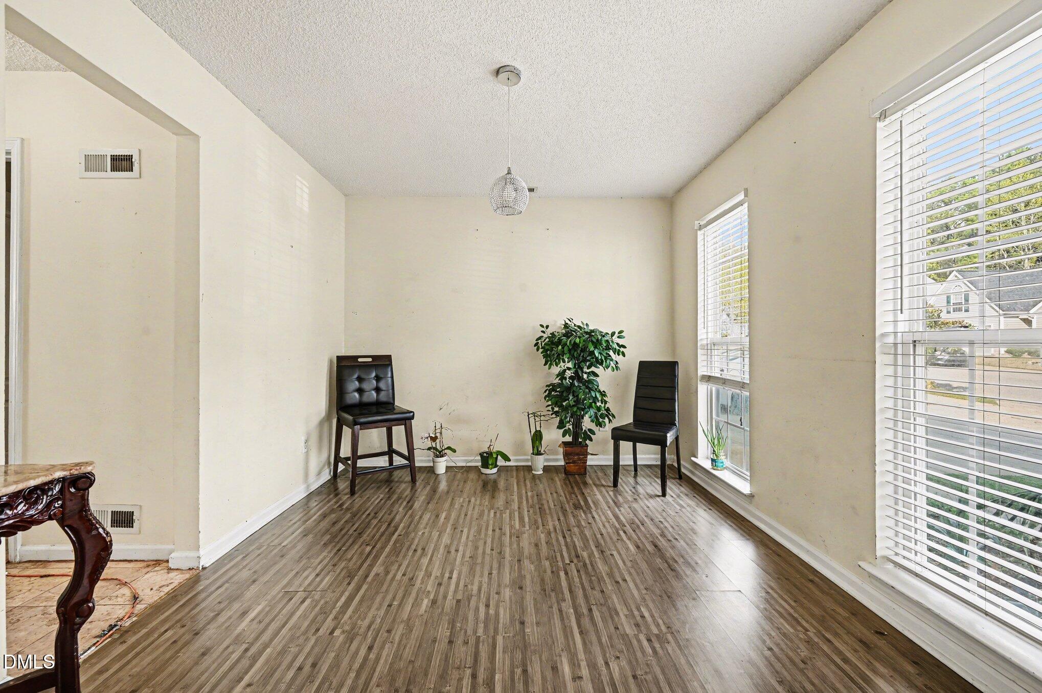 5115 Cardinal Grove Boulevard Raleigh, NC 27616 - Photo 10 of 36 a view of a dining room with furniture and wooden floor