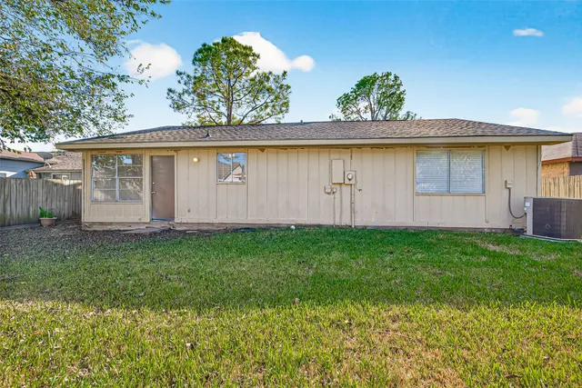 a view of backyard with wooden fence