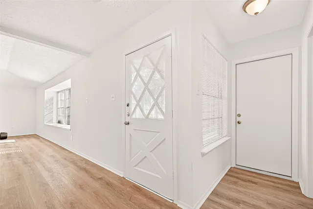 a view of a hallway with wooden floor