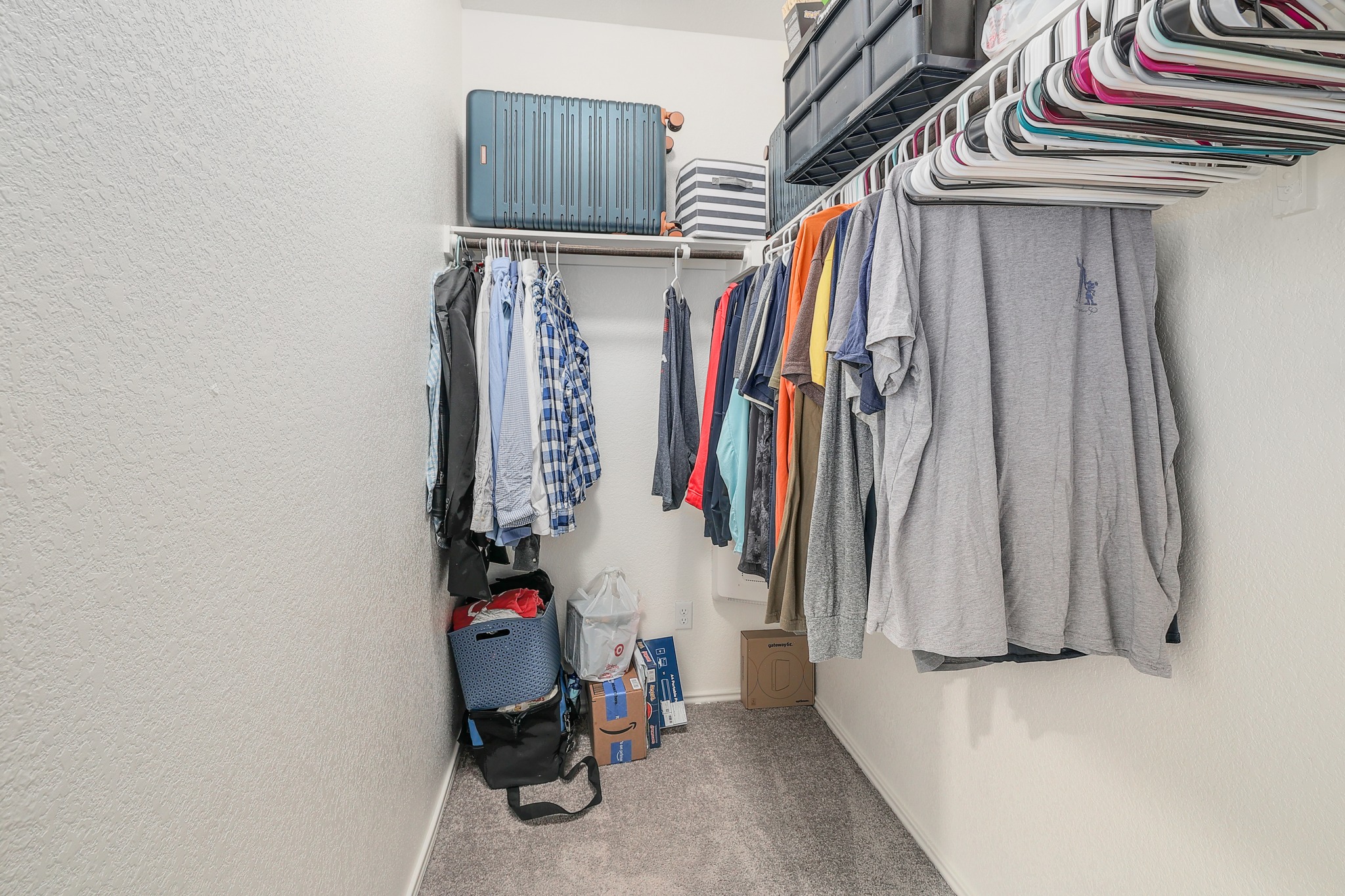 735 Circle Way Jarrell, TX 76537 - Photo 14 of 32 Ample hanging rods and shelving maximize organization in this walk-in closet with plush carpeting.