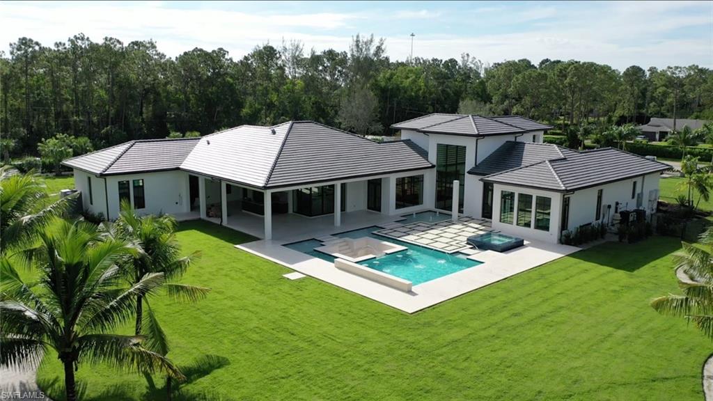 6435 Sable Ridge Lane Naples, FL 34109 - Photo 2 of 8 a aerial view of a house with swimming pool garden view and trees